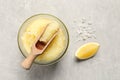 Body scrub with scoop, sea salt and lemon on light grey table, flat lay Royalty Free Stock Photo