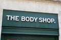 The body shop logo brand and text sign front of green entrance shop
