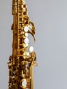 Body of Soprano Sax with keys, part of wind instrument saxophone staying on a white background, vertical, close up Royalty Free Stock Photo