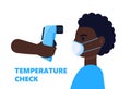 Body temperature check is required. Non-contact thermometer in hand. Black man is wearing mask on the face. Coronavirus prevention Royalty Free Stock Photo