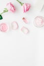 Body treatment with rose flowers and cosmetic set white desk background top view space for text Royalty Free Stock Photo