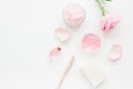 Body treatment with rose flowers and cosmetic set white desk background top view space for text Royalty Free Stock Photo