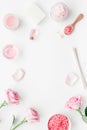 Body treatment with rose flowers and cosmetic set white desk background top view space for text Royalty Free Stock Photo