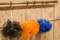 Hanging on hooks body washcloths in blue, orange and black. Royalty Free Stock Photo