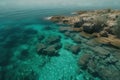 a body of water surrounded by rocks and algae growing on the shore of a beach with clear blue water and a rocky shoreline with