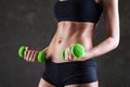 Body of young fit woman lifting dumbbells Royalty Free Stock Photo