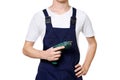 Young man dressed in overalls holding screwdriver in hand, isolated on white background Royalty Free Stock Photo