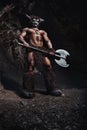 The bodyart man angry minotaur with axe in cave