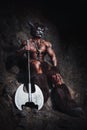 The bodyart man angry minotaur with axe in cave