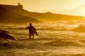 Bodyboarder walkimg in the water