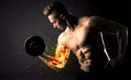 Bodybuilder athlete lifting weight with fire explode arm concept Royalty Free Stock Photo