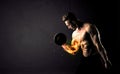 Bodybuilder athlete lifting weight with fire explode arm concept Royalty Free Stock Photo