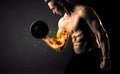 Bodybuilder athlete lifting weight with fire explode arm concept Royalty Free Stock Photo