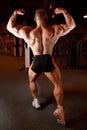 Bodybuilder back demonstrates his muscles