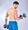 Bodybuilder back, dumbbells and background in studio for fitness, health or training with focus. Man, weightlifting Royalty Free Stock Photo