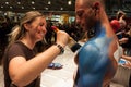 Bodybuilder during a body painting session at Milano Tattoo Convention Royalty Free Stock Photo