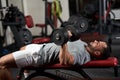 Bodybuilder doing bench press with dumbbells Royalty Free Stock Photo
