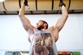 Bodybuilder doing chin ups, working out