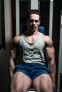 Bodybuilder doing heavy weight exercise for legs on machine leg extensions Royalty Free Stock Photo