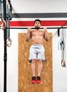 Bodybuilder doing pull ups in gym Royalty Free Stock Photo