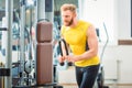 Bodybuilder exercising triceps pushdown at the rope cable machine Royalty Free Stock Photo