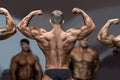 Bodybuilder flexing back and biceps.