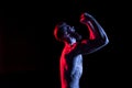 Bodybuilder gesturing and yelling isolated on black with dramatic lighting