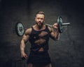 Bodybuilder holds barbell over dark grey background.