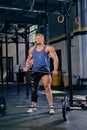 Bodybuilder holds cross fit hammer.