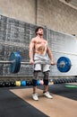 Bodybuilder lifting heavy barbell weights