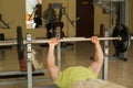 Bodybuilder lifts weights.