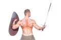 Bodybuilder man posing with a sword and shield isolated on white background. Serious shirtless man demonstrating his Royalty Free Stock Photo