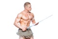 Bodybuilder man posing with a sword isolated on white background. Serious shirtless man demonstrating his mascular body. Royalty Free Stock Photo