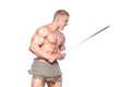 Bodybuilder man posing with a sword isolated on white background. Serious shirtless man demonstrating his mascular body. Royalty Free Stock Photo