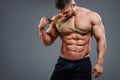 Bodybuilder measuring chest with tape measure Royalty Free Stock Photo