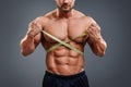 Bodybuilder measuring waist with tape measure Royalty Free Stock Photo