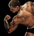 Bodybuilder posing. Beautiful sporty guy male power. Royalty Free Stock Photo