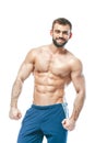 Bodybuilder posing. Beautiful sporty guy male power. Fitness muscled in blue shorts. on isolated white background. Man Royalty Free Stock Photo