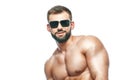 .bodybuilder posing. Beautiful sporty guy male power. Fitness muscled in blue shorts and sunglasses. on isolated white Royalty Free Stock Photo