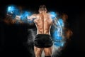 Athlete bodybuilder in blue energy lights. Boxing man posing on black background. Sporty guy male . Fitness muscled man Royalty Free Stock Photo