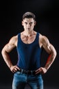 Bodybuilder posing. Beautiful sporty guy male power. Fitness muscled man in shirt.