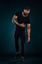 Strong and fit man bodybuilder. Sporty muscular guy athlete. Sport and fitness concept. Men`s fashion in full height. Royalty Free Stock Photo