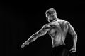 Bodybuilder posing. Fitness muscled man on dark background. Royalty Free Stock Photo