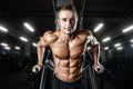 Bodybuilder pumping up chest muscles push-ups bars Royalty Free Stock Photo