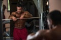 Bodybuilder resting after doing heavy weight exercise