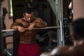 Bodybuilder resting after doing heavy weight exercise