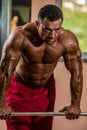 Bodybuilder resting after doing heavy weight exercise Royalty Free Stock Photo