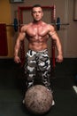 Bodybuilder Resting After Picking Up A Stone Royalty Free Stock Photo