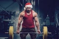 Bodybuilder in Santa Claus costume in gym