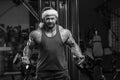 Bodybuilder in Santa Claus costume in the gym